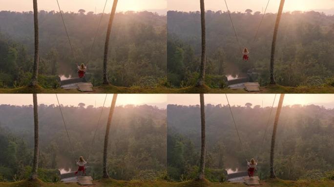 慢动作女人在日出时在热带雨林上摇摆旅行女孩坐在秋千上享受风景享受假期自由享受快乐的假期生活方式