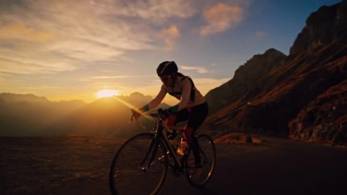 骑自行车的人在阳光明媚的田园诗般的日出山上骑自行车