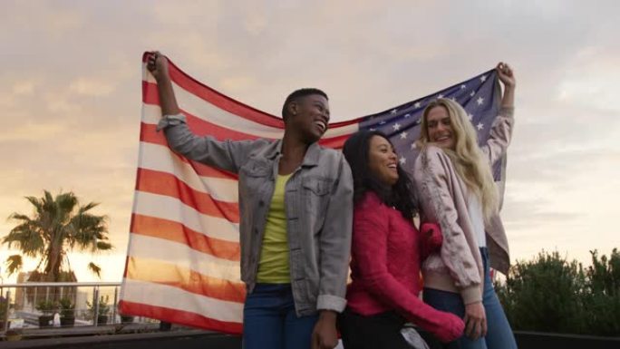 年轻女性在屋顶上跳舞并悬挂美国国旗