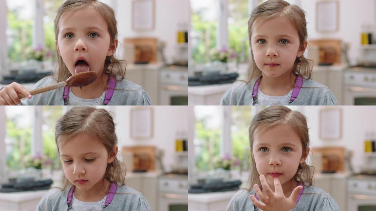 可爱的小女孩，双手沾满巧克力舔手指，在厨房里玩得开心，顽皮的孩子在家里享受美味佳肴