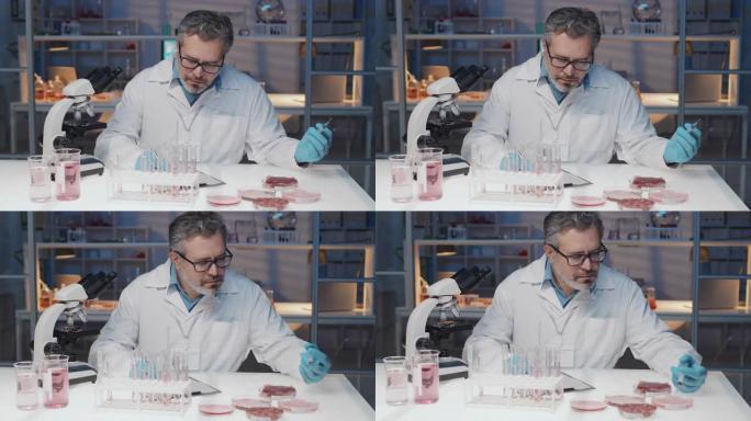 实验室外套中的成熟科学家尝试体外肉并做笔记