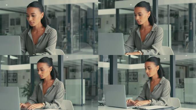 4k视频片段，一位迷人的年轻女商人独自坐在办公室里并使用笔记本电脑