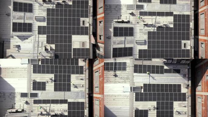 建筑屋顶上的太阳能，无人机和建筑工人。航空、太阳能电池板和工业团队致力于项目管理、城市电网物流和工程
