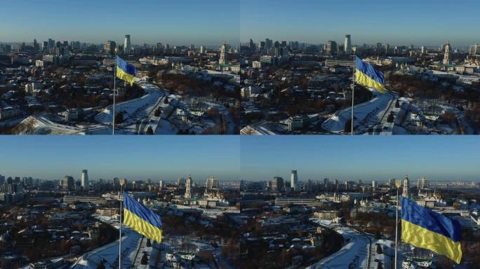 空中拍摄的大型乌克兰国旗在基辅佩切尔斯克拉夫拉附近挥舞，美丽宁静的冬季城市象征风景。