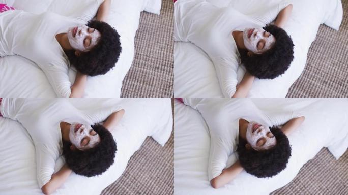 戴口罩躺在床上的非裔美国妇女