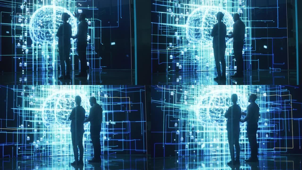 两个不同的同事的后视图看着带有神经网络可视化动画的大屏幕。专业计算机数据科学家讨论并致力于监视私人信