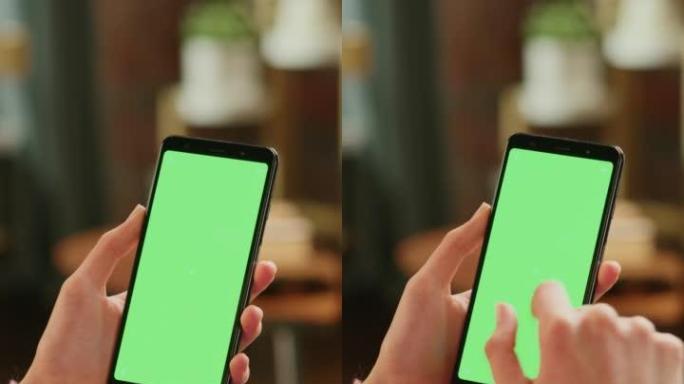 垂直屏幕: 带有绿色屏幕模拟显示的智能手机上的女性手动滚动供稿。女性在家休息，并在移动设备上查看社交