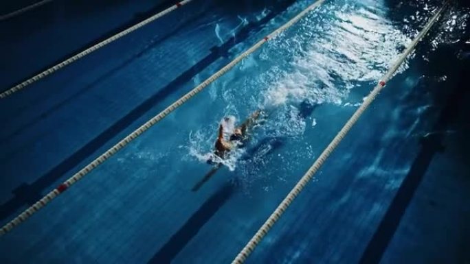 空中: 游泳池中的女游泳者。职业运动员仰泳式游泳，立志夺冠。深色戏剧性的颜色，电影圈车道灯，跟踪荷兰