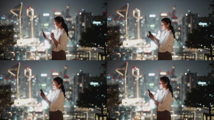 亚洲妇女晚上在城市的智能手机上进行视频通话