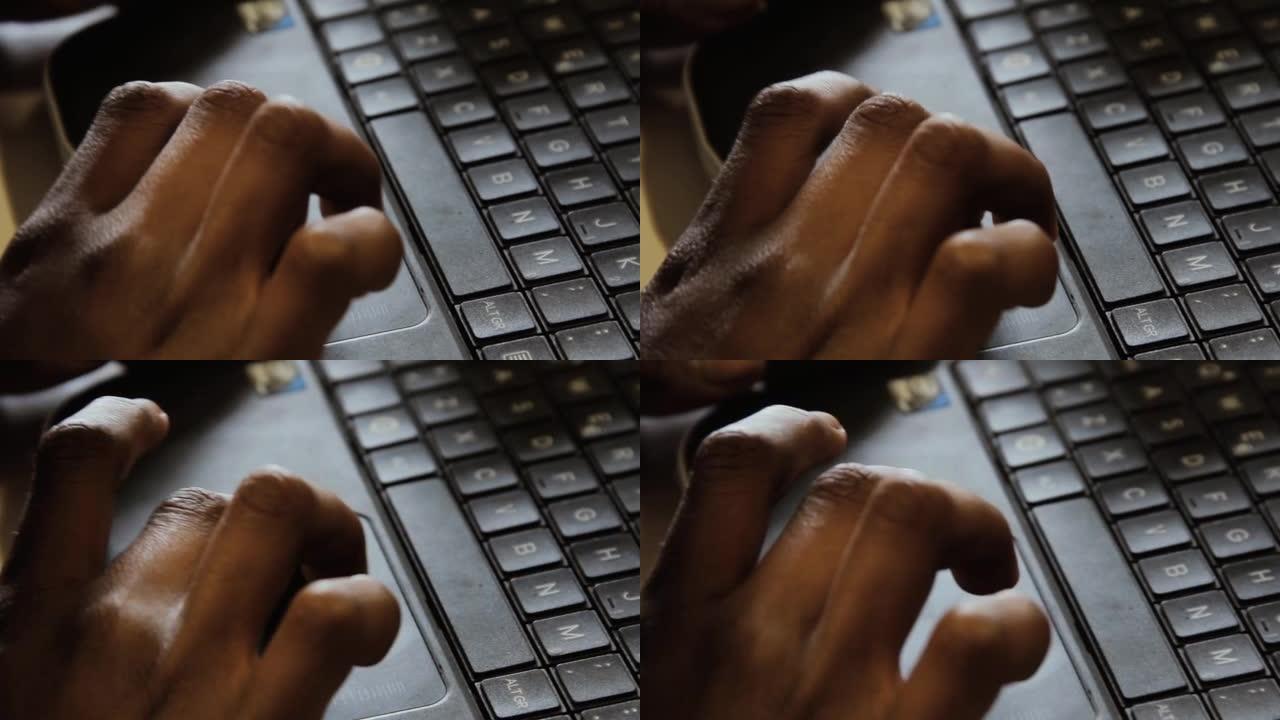 盲人学生的手在电脑课上学习使用键盘。特写。