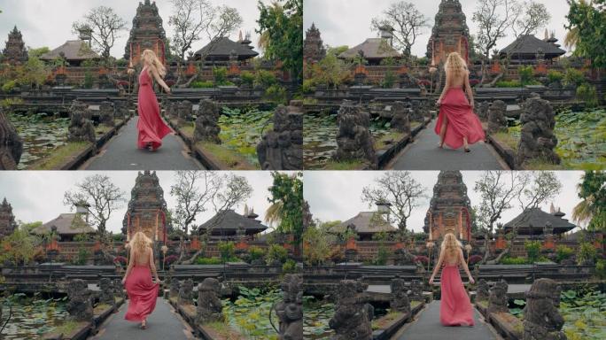 快乐的女人在萨拉斯瓦蒂寺庙跳舞，庆祝旅行，享受印度尼西亚巴厘岛的文化4k