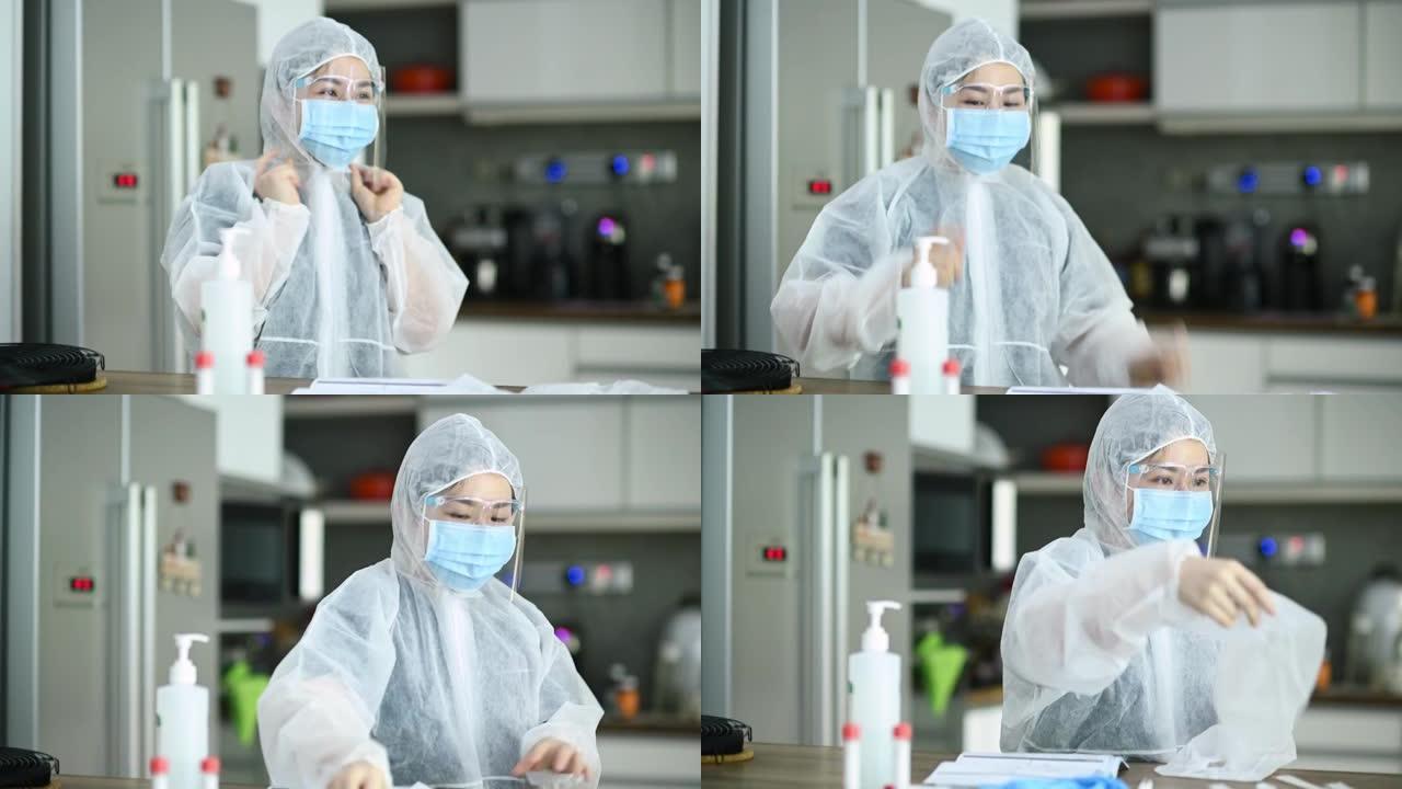 亚洲华裔女医生在进行鼻拭子之前先穿着PPE防护工作服预防措施