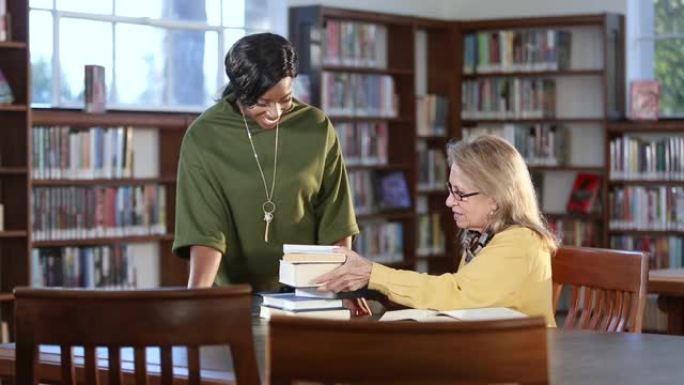 图书管理员帮助老年人学习书籍