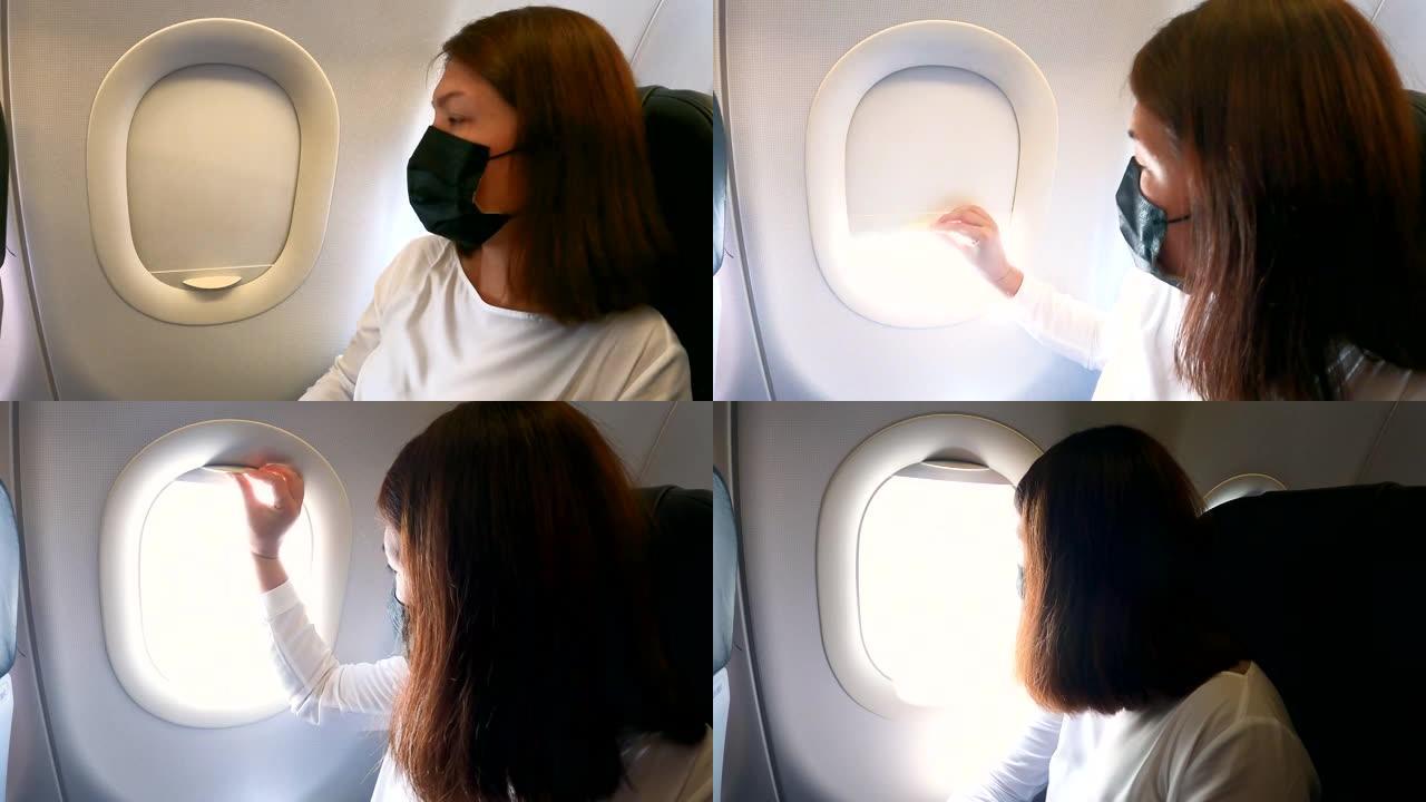 女乘客在飞行过程中打开飞机窗户并向飞机窗外看