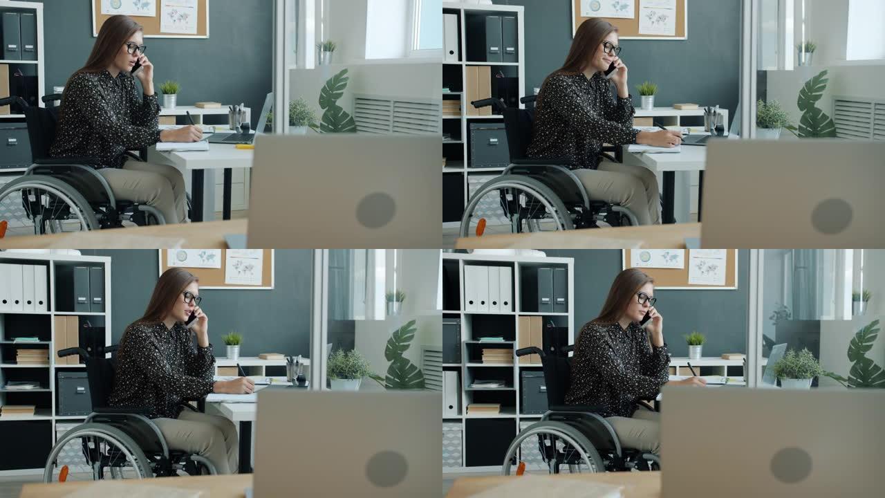 坐在轮椅上的残疾女商人在办公室打电话的慢动作