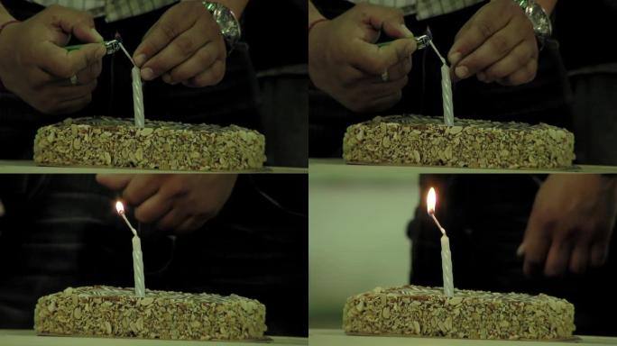 阿根廷布宜诺斯艾利斯省一所监狱内，一名狱警为一名囚犯在生日蛋糕上点燃蜡烛。特写。