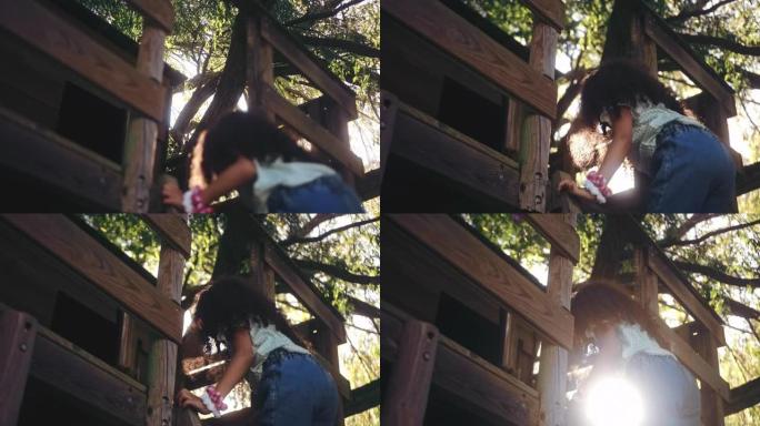 可爱的小女孩爬上树屋的梯子