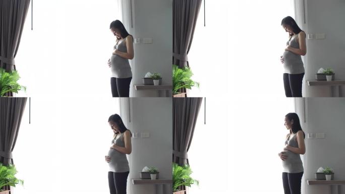 亚洲孕妇在房间里摸肚子