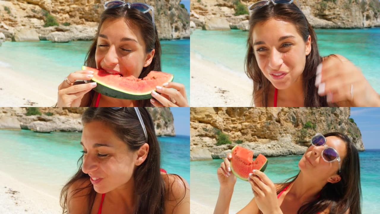 一个迷人的年轻女子站在意大利的海滩上吃西瓜的4k视频片段