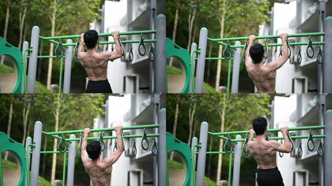亚洲中国男运动员的人背，上身裸露的肌肉在操场上锻炼