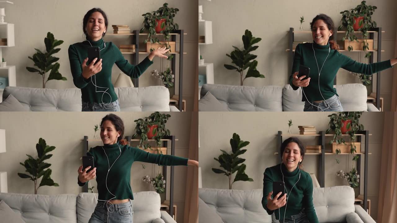 手持智能手机的女性视频记录器为频道录制她的舞蹈视频