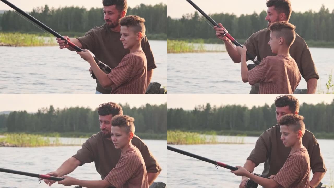 父亲教男孩钓鱼户外活动父子时刻水域