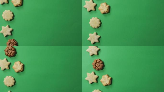 绿色背景上有复制空间的星形和形状的圣诞饼干动画