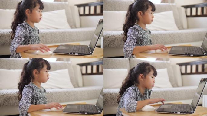 小女孩在家用笔记本电脑在线学习