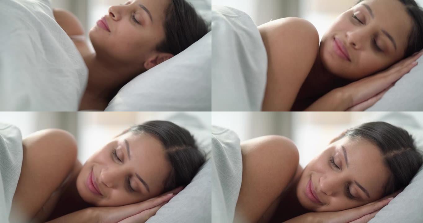 4k视频片段，一名年轻女子早上在家躺在床上放松