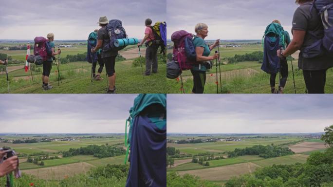 SLO MO五名老年妇女在乡村徒步旅行时欣赏美景