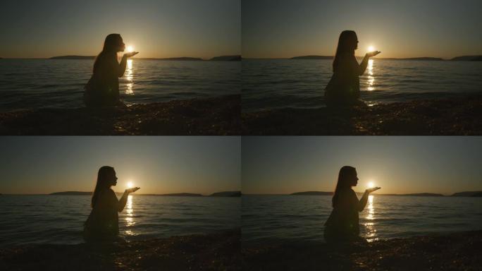 日落时在海滩许愿的女人