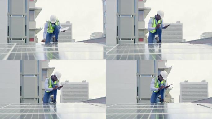 一个年轻人在建筑物的屋顶上安装太阳能电池板时写笔记