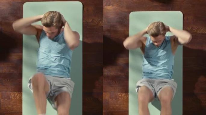 垂直屏幕顶视图运动: 漂亮的家伙躺在家里的运动垫上做腹肌肘到膝仰卧起坐。肌肉发达，健康，非常英俊的运