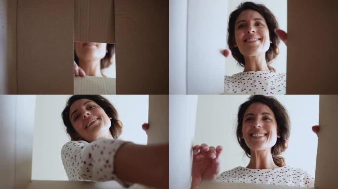 纸箱快乐女人打开包裹的特写镜头。