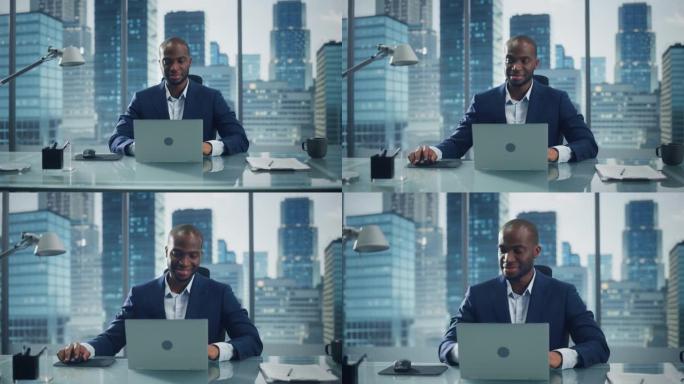 体贴的黑人商人在他的大城市办公室里在笔记本电脑上工作的肖像。魅力型数字企业家为电子商务战略评估做数据