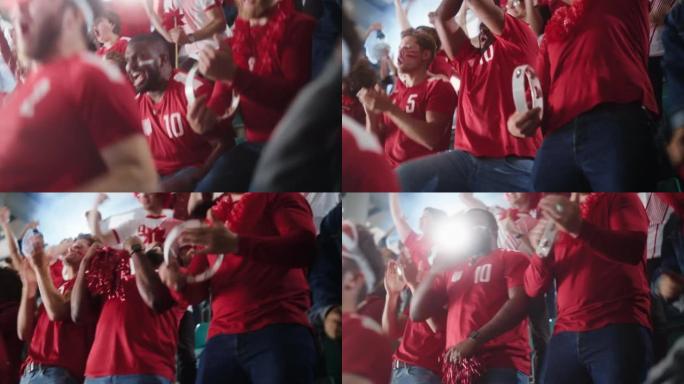 体育馆足球比赛: 各种各样的球迷为他们的红队获胜而欢呼。人们庆祝进球，冠军胜利。带彩绘面孔的人群欢呼