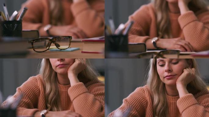 4k视频片段，一名年轻女子在学习时看起来很无聊