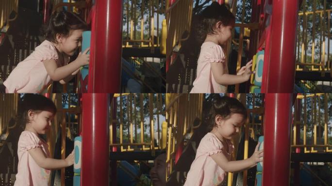 特写亚洲幼儿2年夏天和她的祖父和祖母在公园玩玩具