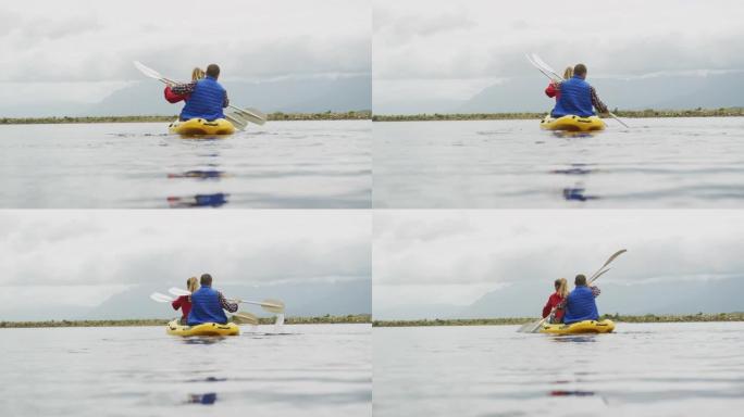高加索夫妇在山上旅行时玩得很开心，一起在湖上划皮艇