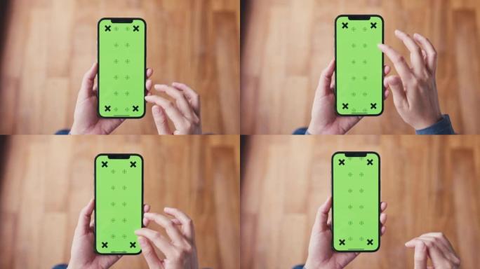 家中女性手中的绿屏模板智能手机特写镜头