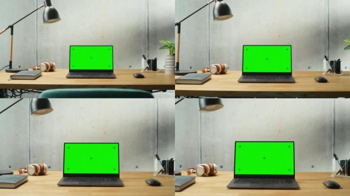笔记本电脑，模拟绿屏显示站在桌子上。高效简约的现代办公空间设计，保证和谐与生产力。模拟色度键监视器