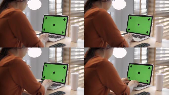 使用笔记本电脑绿屏的女人