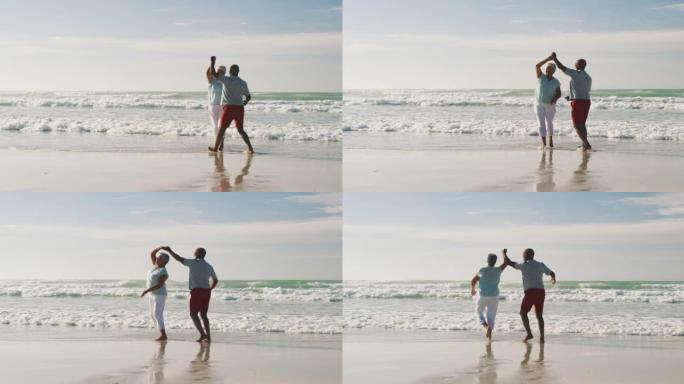 老年非裔美国夫妇在海滩上微笑跳舞