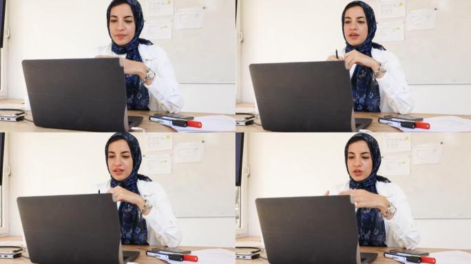 伊斯兰女商人在办公室视频通话