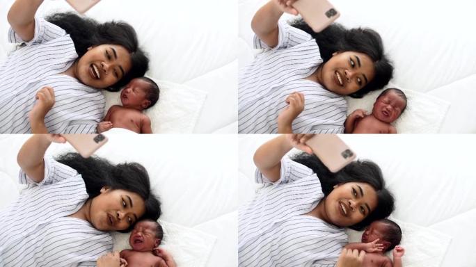 妈妈和她的新生男婴用智能手机相机自拍