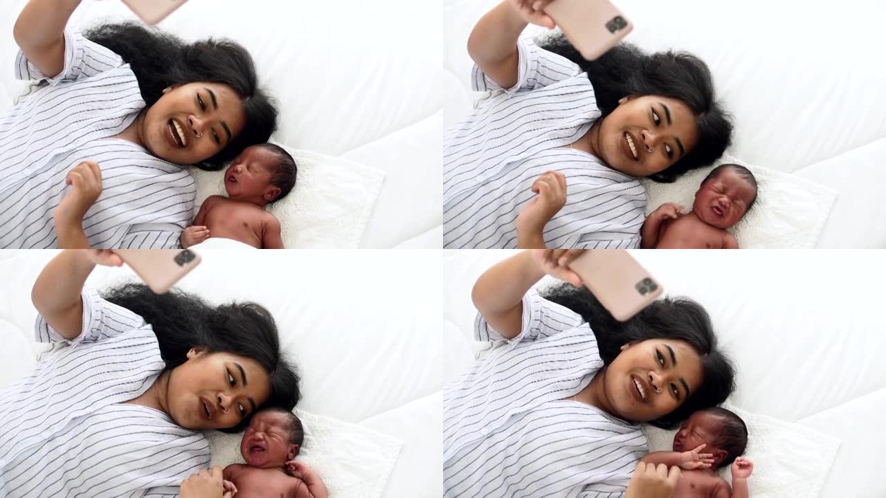 妈妈和她的新生男婴用智能手机相机自拍