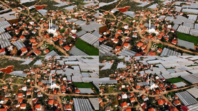 从上面看温室和小村庄的无人机景观。土耳其的农业。直接在上面射击