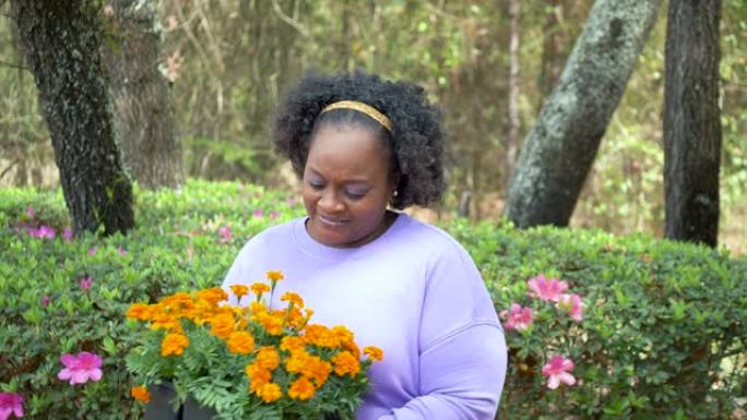 成熟的非裔美国妇女在院子里种花