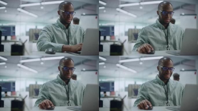 现代办公室: 在笔记本电脑上工作的有动力的黑人IT程序员的肖像。男性专家创建网站，软件工程师开发应用