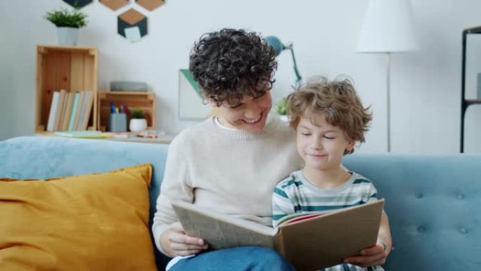 慢动作幸福家庭母子读书在家室内微笑